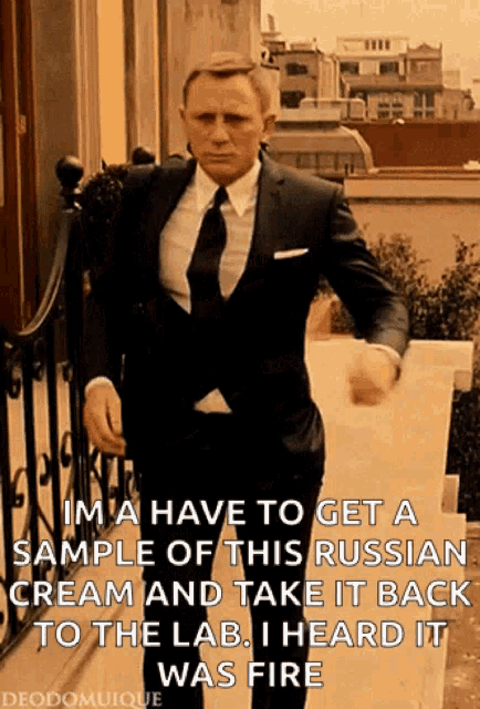 a man in a suit and tie is standing on a balcony with a caption that says im a have to get a sample
