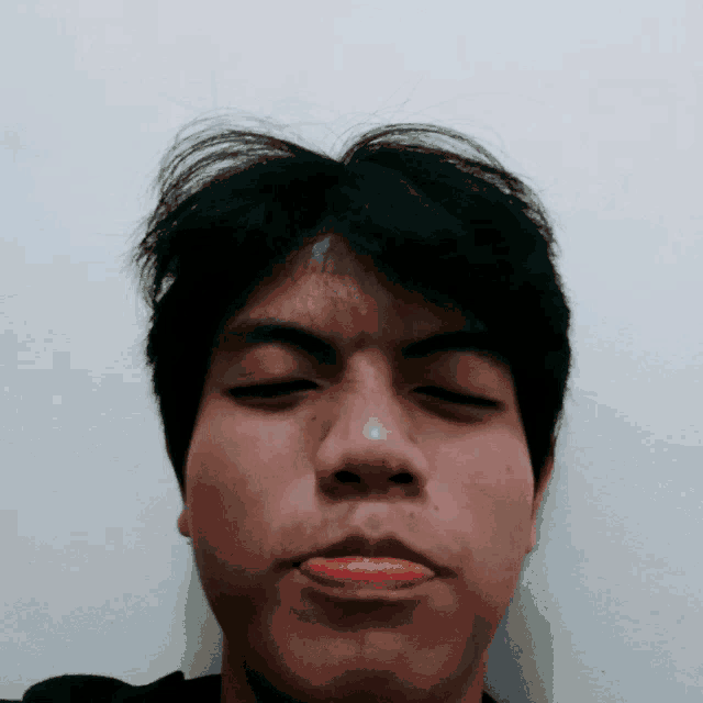a man with his eyes closed and his mouth open