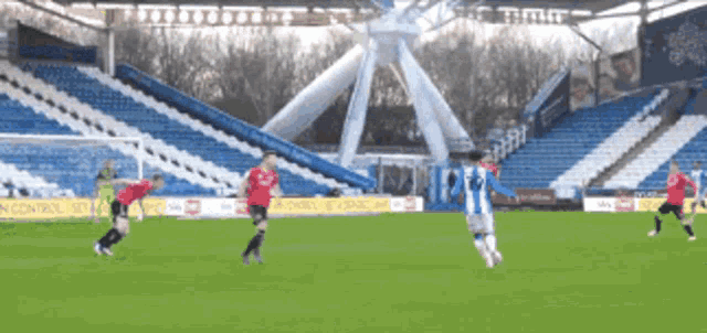 a soccer game is being played in an empty stadium with ads for sky sports