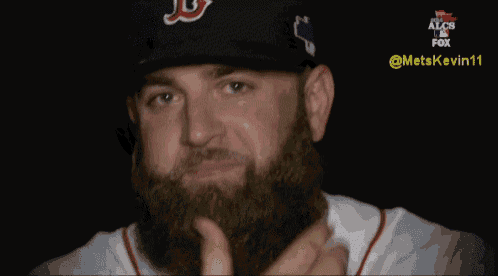 a man with a beard wears a red sox hat
