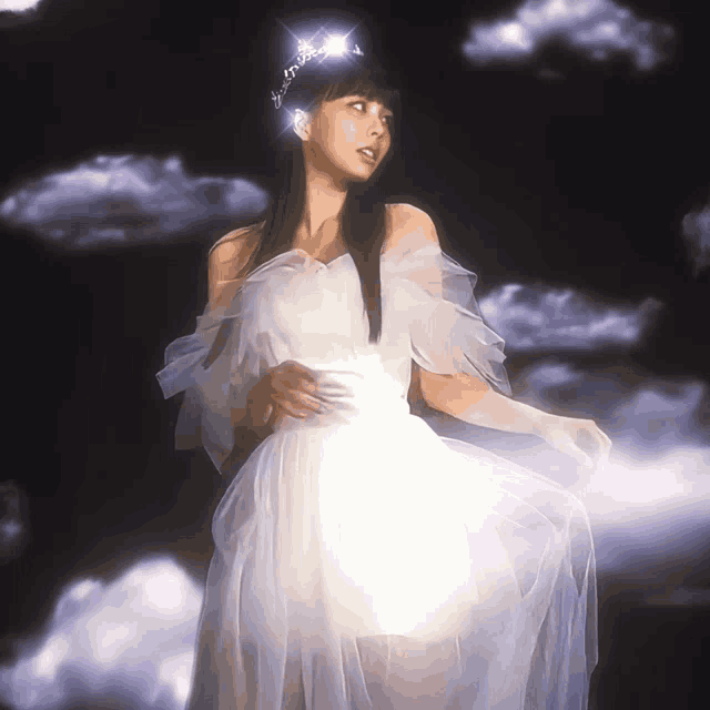 a woman in a white dress and tiara stands in front of a cloudy sky