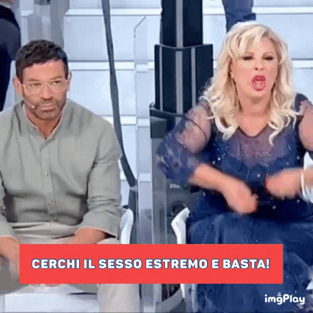 a man and a woman are sitting next to each other with the words cerchi il sesso estremo e basta behind them