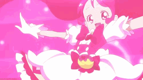 a girl with long pink hair and a bunny ear is standing on a pink surface .