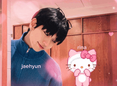 a man in a blue sweater is next to a hello kitty