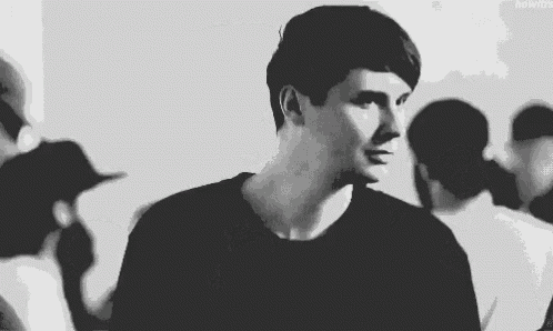 a black and white photo of a man in a black shirt