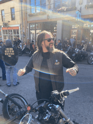 a man wearing a black shirt that says " i was born the day my mom died "