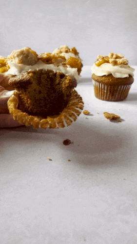 a person is taking a bite out of a cupcake with a bite taken out of it