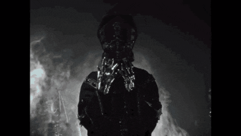 a black and white photo of a ghost in a dark room .