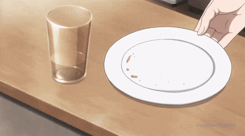 an empty glass sits next to an empty plate