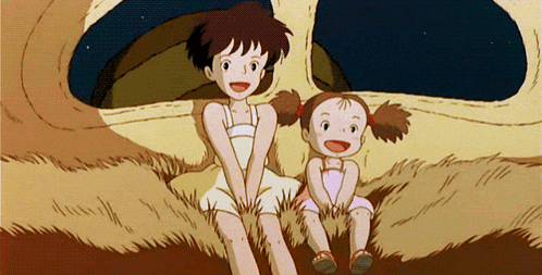 two little girls are sitting next to each other in the grass and smiling