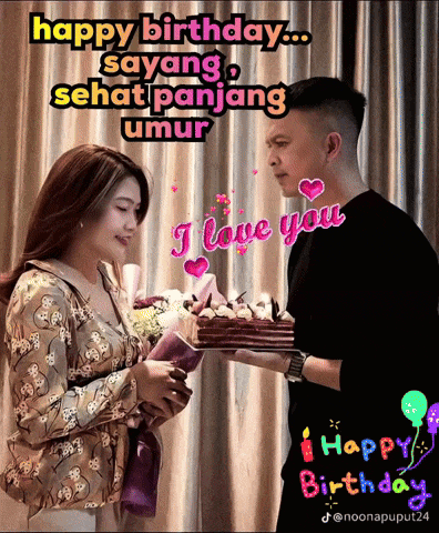 a man is holding a cake and a woman is holding flowers and says " happy birthday "