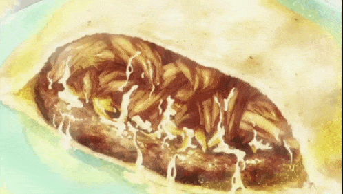 a close up of a sandwich with meat and cheese on a plate