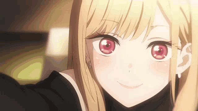 a blonde anime girl with red eyes is smiling and looking at the camera