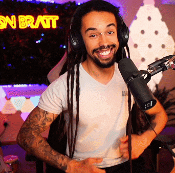 a man wearing headphones stands in front of a microphone in front of a sign that says son bratt