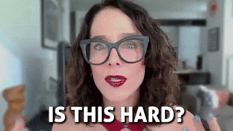 a woman wearing glasses and red lipstick is asking , `` is this hard ? ''