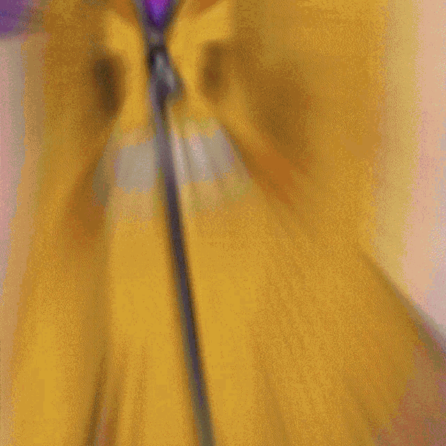 a blurry drawing of a person wearing a yellow jacket and a green necklace