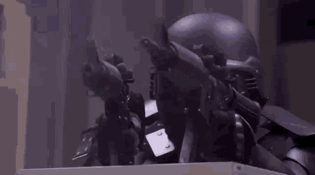 a person in a purple helmet is standing in a room with smoke coming out of a box .