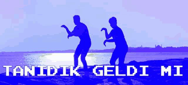 two people dancing on the beach with the words tanidik geldi mi