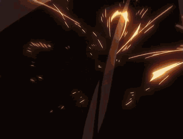 a silhouette of a person is surrounded by flames in a dark room