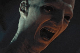 a close up of a person 's face with their mouth wide open