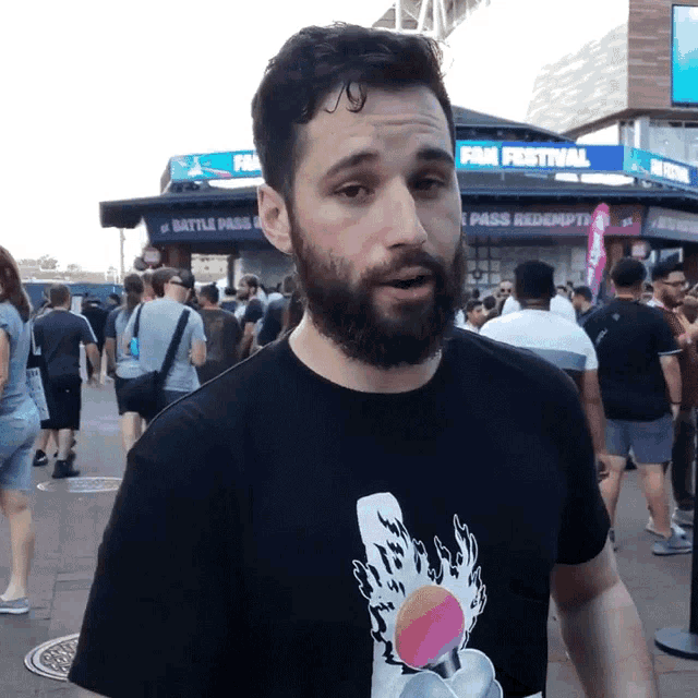 a man with a beard is standing in front of a sign that says film festival
