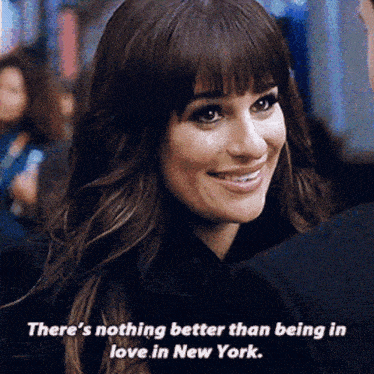 a woman is smiling with the words " there 's nothing better than being in love in new york "