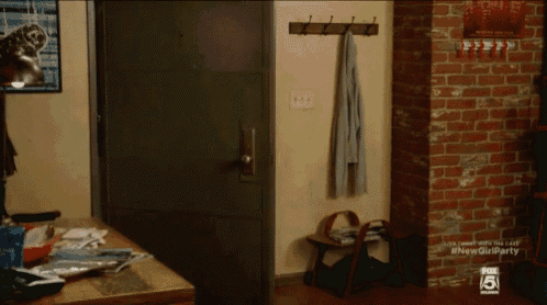 a room with a brick wall and the number 5 on it