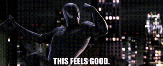 a spider man is flexing his muscles in front of a city skyline and the words this feels good .
