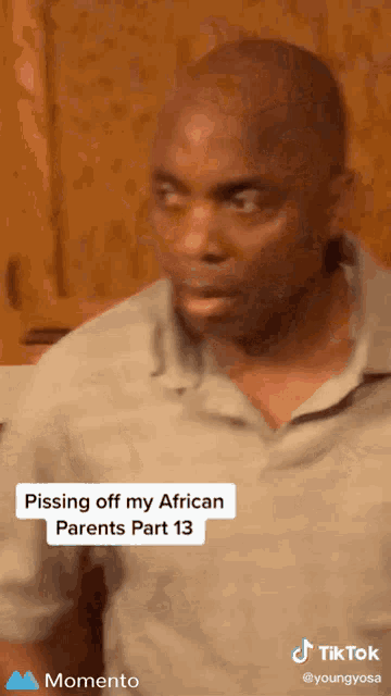 a man 's face is shown in a tiktok video with the caption pissing off my african parents part 13
