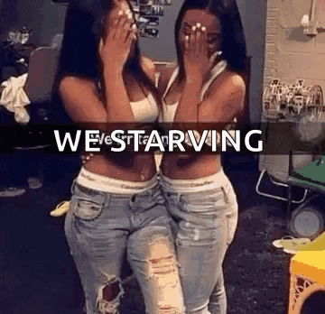 two women are standing next to each other in a room covering their faces with their hands .