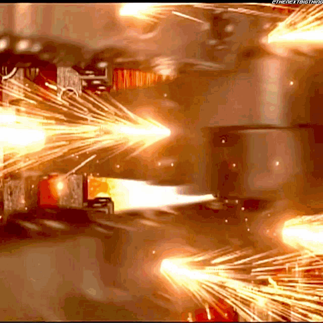 a close up of a machine with sparks coming out of it and the words the next thing on the bottom
