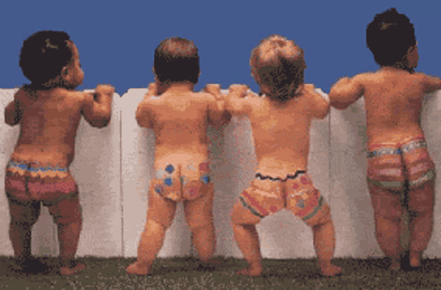 four babies are standing in front of a white fence with their butts painted