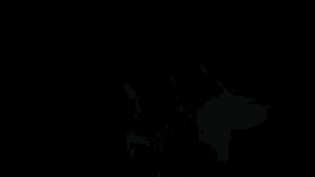 a man with long hair is wearing a black sweater and a necklace with the words 9 half bun above him