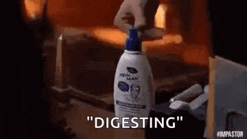 a person is holding a bottle of shampoo and says `` digesting '' .