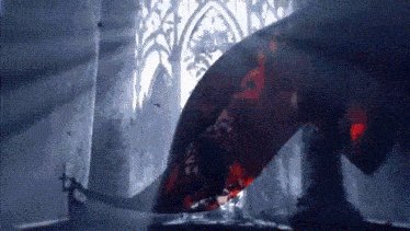 a person is standing in a dark room with a red light coming out of the ceiling .