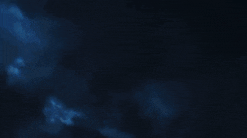 a blue light is coming out of a dark background