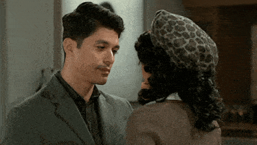a man and a woman are looking at each other