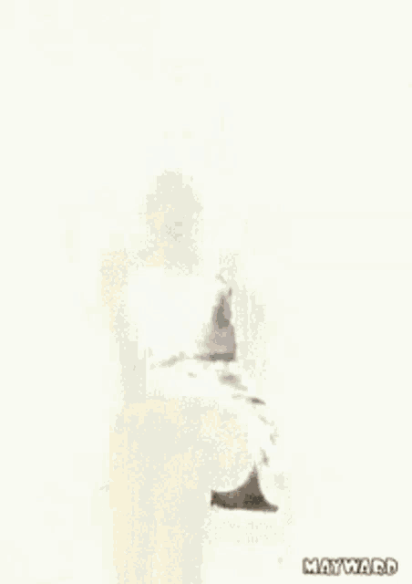 a woman in a black dress is sitting on a chair with her legs crossed and her mouth open ..