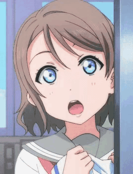 a close up of a girl 's face with her mouth open
