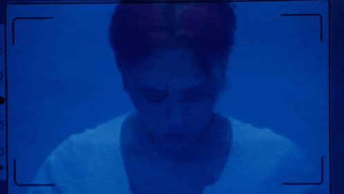 a man 's face is shown on a blue screen