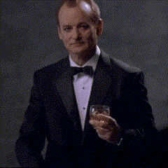 a man in a tuxedo is holding a glass of whiskey and saying i love you more