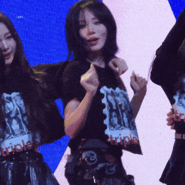 a woman wearing a black shirt that says triple