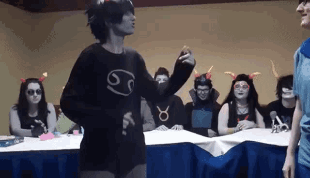 a group of people are gathered around a table with one wearing a shirt that says cancer
