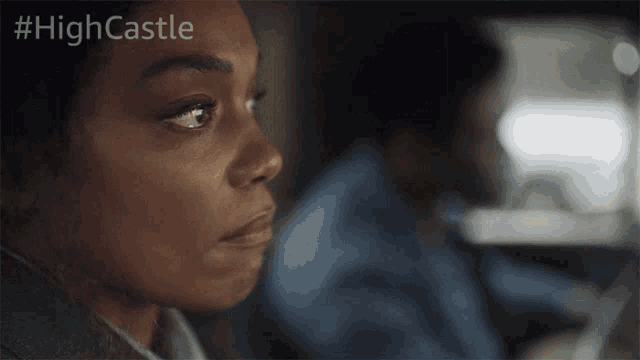 a close up of a woman 's face with the hashtag #highcastle on the bottom
