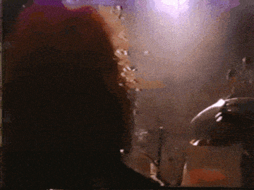 a purple light is shining on a person 's head