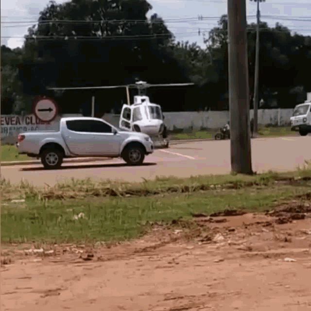 a white truck is parked in front of a sign that says " every club "