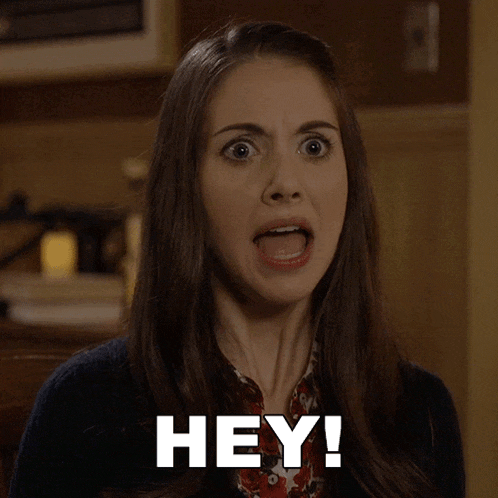 a woman with a surprised look on her face and the words hey written on her face