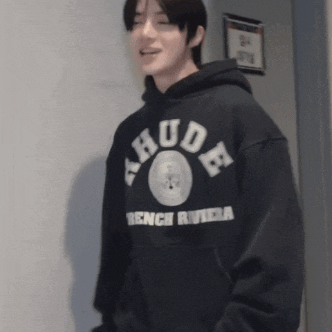 a man wearing a black hoodie that says rude