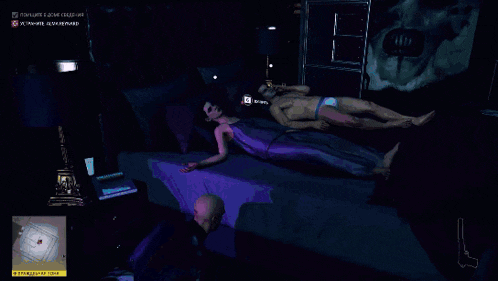 a man without a shirt is laying on a bed in a dark room