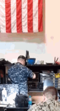 a man in a military uniform is working in a kitchen
